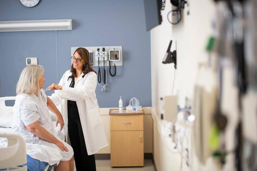 GVSU Doctor of Nursing Practice student treating a patient in a simulation lab.